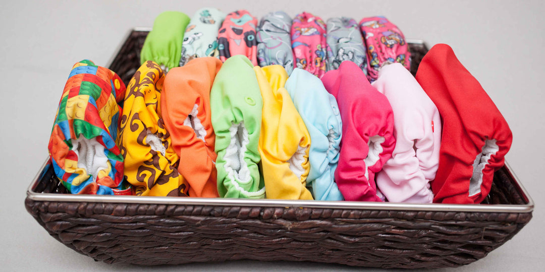 Colorful collection of Reusable Potty Training Nappies stacked neatly in a woven basket.
