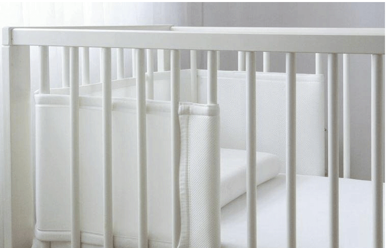Baby Cot Bumper Half Length installed in a modern white crib, designed for safety and comfort.