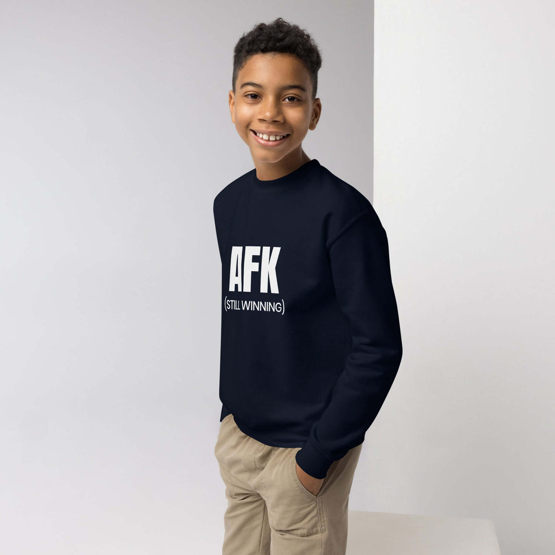 AFK Youth crewneck sweatshirt worn by a smiling boy, featuring bold text design on a navy background.