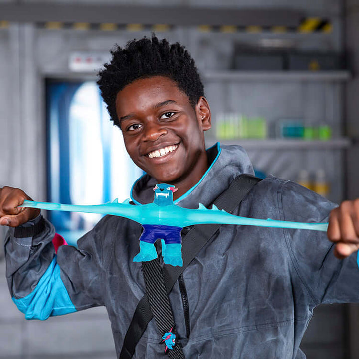Child playing with MrBeast Lab Goo Jit Zu Iconic Panther, stretching the squishy hero figure with a big smile.