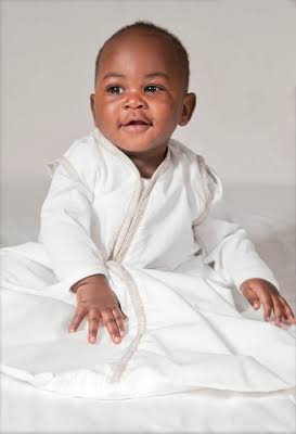 Joey Swag Baby Sleeping Bag worn by a happy baby, showcasing the lightweight and safe design.